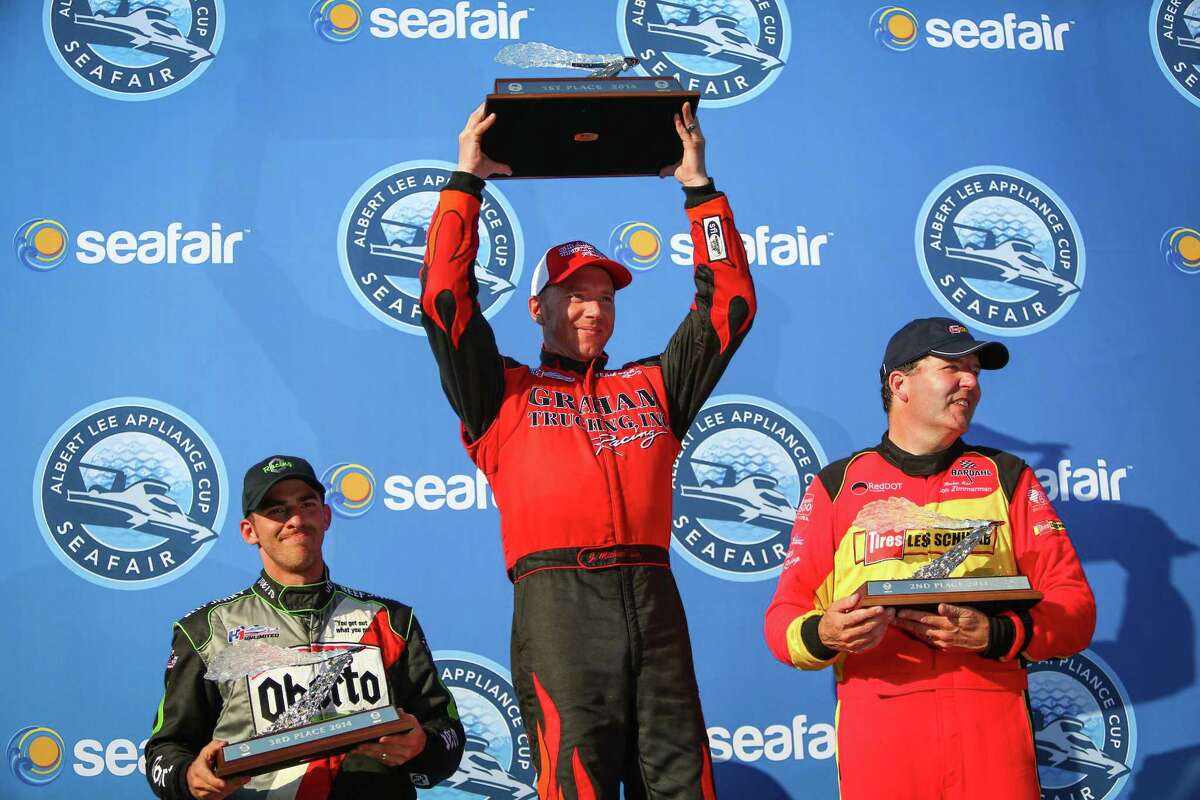 From left, Jimmy Shane of the Oberto Unlimited Hydroplane, J. Michael Kelly of the Graham Trucking boat and Jon Zimmerman of the Les Schwab Tires - Team Red Dot boat hoist their trophies after Kelly won the Albert Lee Appliances Seafair Cup during Seafair on Sunday, August 3, 2014.
