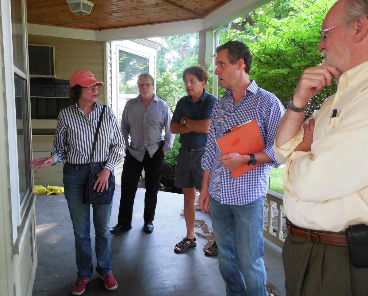 Selectman Helen Garten, chair of the Kemper-Gunn Advisory Group, gets ready to lead a tour of the historic house Monday morning. Plans are to re-purpose the structure and relocate it from Church Lane to the nearby Baldwin parking lot. With Garten are (from left) Matt Mandell, Representative Town Meeting and advisory group member; resident Don Bergmann; Morley Boyd, a member of the Downtown Steering Committee, and Joseph Strickland, advisory group member and chairman of the town's Public Site and Building Committee.
