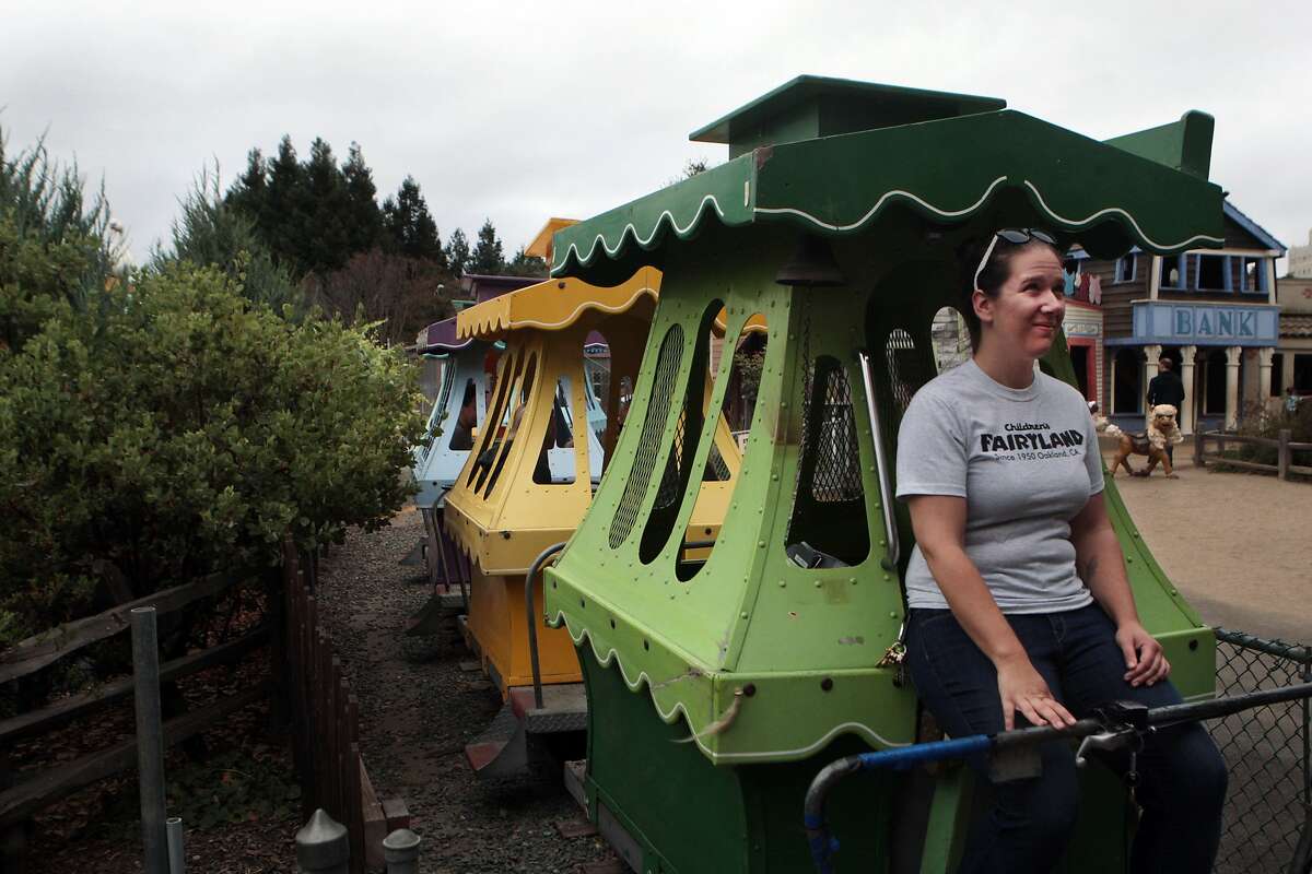 Ride operator Adrienne Suzio looks up at guests on the Yankee Doodle Bridge while operating the Jolly Trolly at Children's Fairyland at Lake Merritt on Sunday, August 3, 2014 in Oakland, Calif. The Jolly Trolly has been in operation since 1954. Suzio said its design was based on the trolley in the newspaper comic strip, "Toonerville Folks." Suzio, who was born and raised in Oakland, said she visited Fairlyland as a child and began working at the park as a ride operator two years ago. She said the Jolly Trolly is her favorite ride.