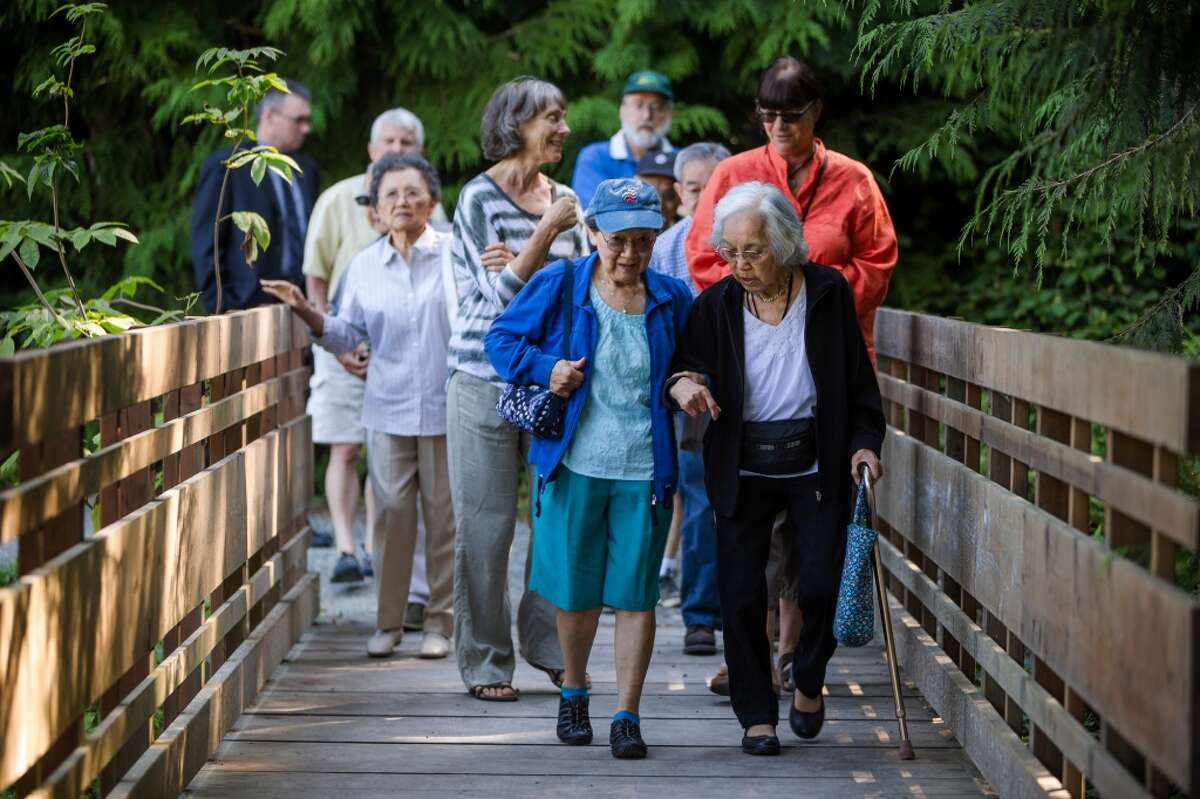 Yukiko Nakamura, right, a Japanese American survivor of the World War II internment camps, is walked by her friend, Kathleen Yukawa, center, to visit the site of the newly renamed Bainbridge Island Japanese American Exclusion Memorial Monday, August 4, 2014, on Bainbridge Island, Wash. The site, designed by National Humanities Medal winning architect Johnpaul Jones, is the only national memorial to the internment of Japanese Americans not located at an incarceration site. (Jordan Stead, seattlepi.com)