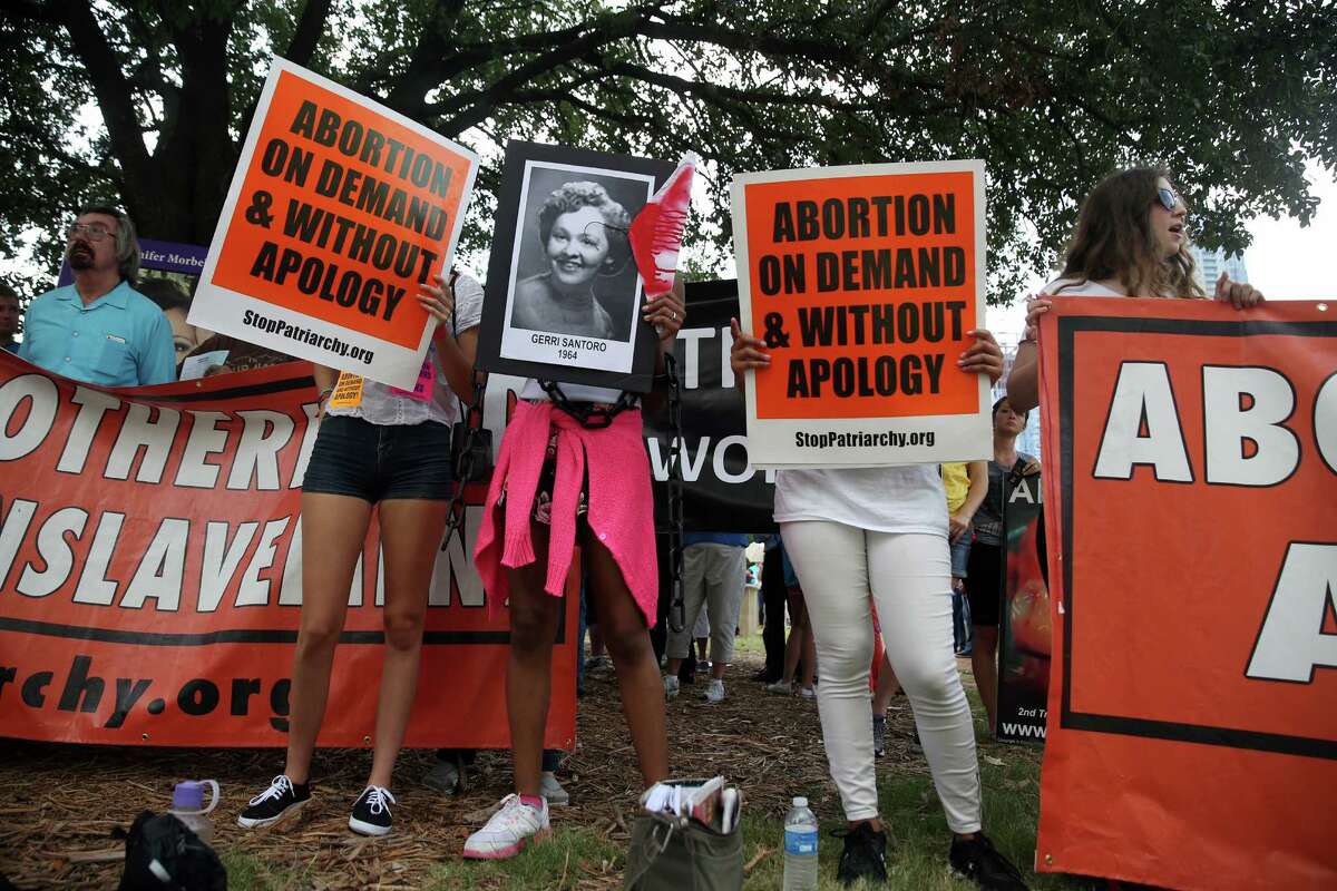 Abortion-rights activists rally near the Austin courthouse where a hearing on Texas' law began Monday.