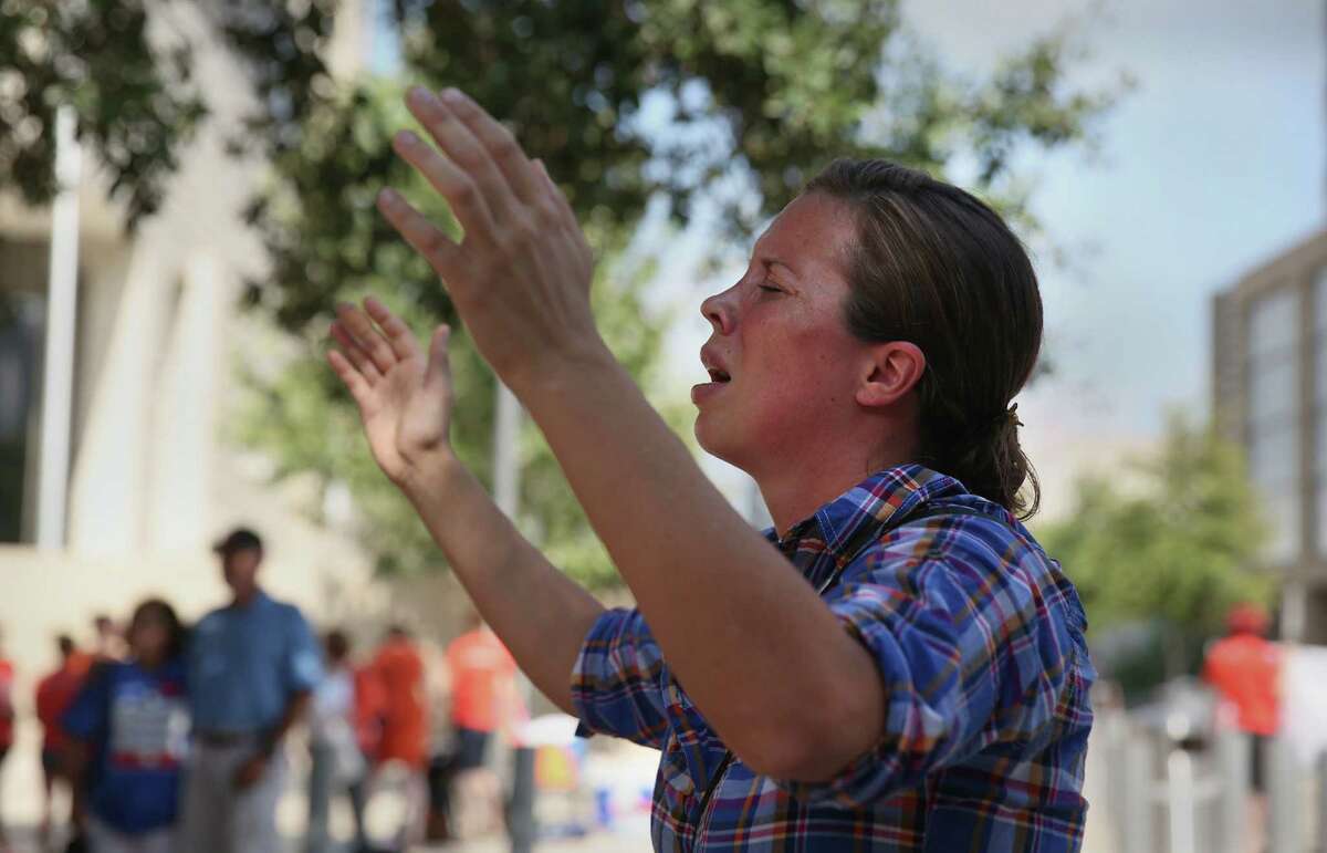 Anti-abortion protester Sara Holland prays near the federal courthouse in Austin, where groups on both sides of the abortion issue held rallies.