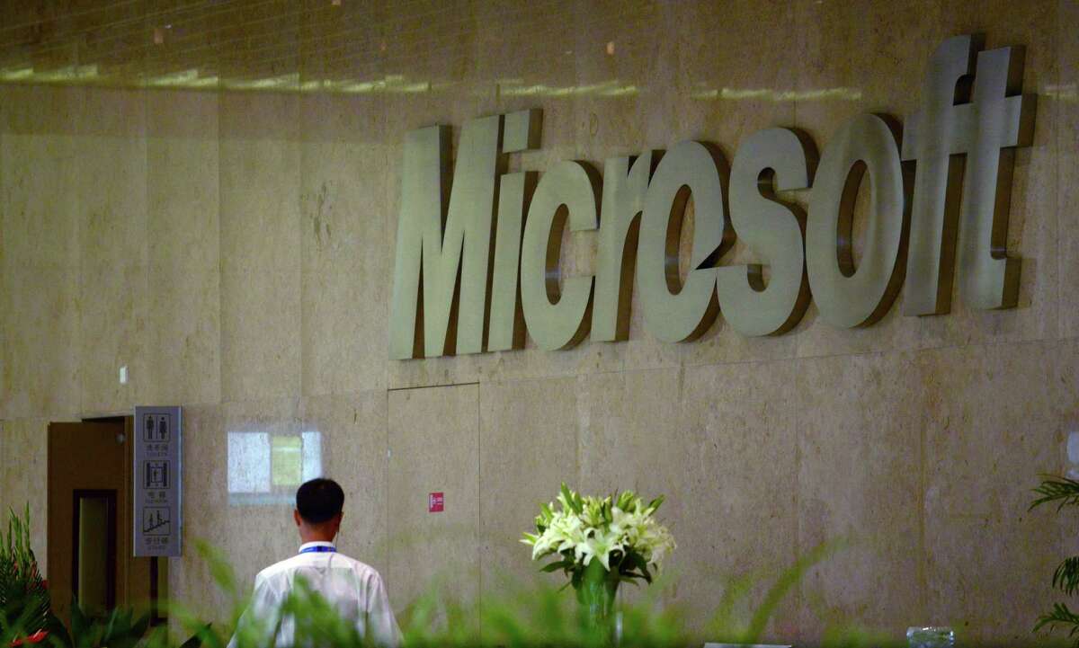 A man walks past a Microsoft logo at a buliding in Beijing on July 29, 2014. China is investigating Microsoft for allegedly operating a monopoly in its market, the government said on July 29, as it took aim at the US software giant over business practices. AFP PHOTO / WANG ZHAOWANG ZHAO/AFP/Getty Images