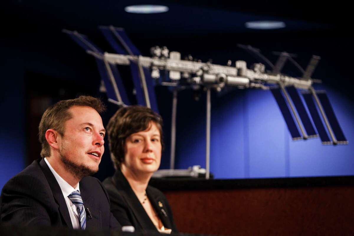 Elon Musk, CEO of SpaceX, (left) fields questions while sitting beside Holly Ridings, NASA Flight Director (right) during a press conference involving NASA and SpaceX officials to discuss the upcoming SpaceX Demonstration Mission after a flight readiness review of a Dragon spacecraft flying to the International Space Station, at Johnson Space Center, Monday, April 16, 2012, in Houston.