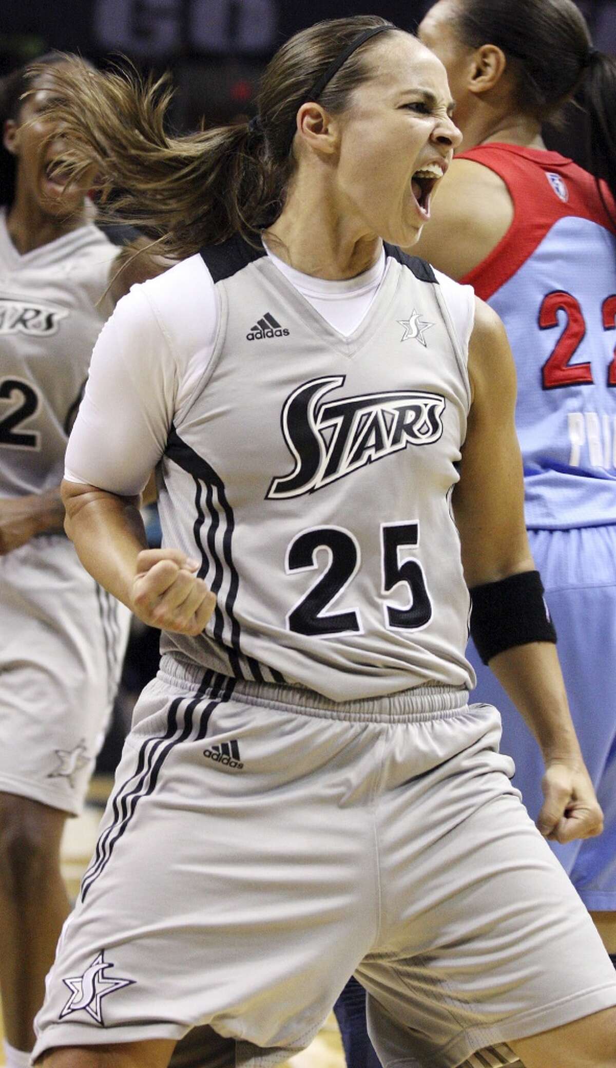 Stars' Becky Hammon celebrates after a score and being fouled by Dream's Aneika Henry (not pictured) during first half action Friday, July 13, 2012 at the AT&T Center.