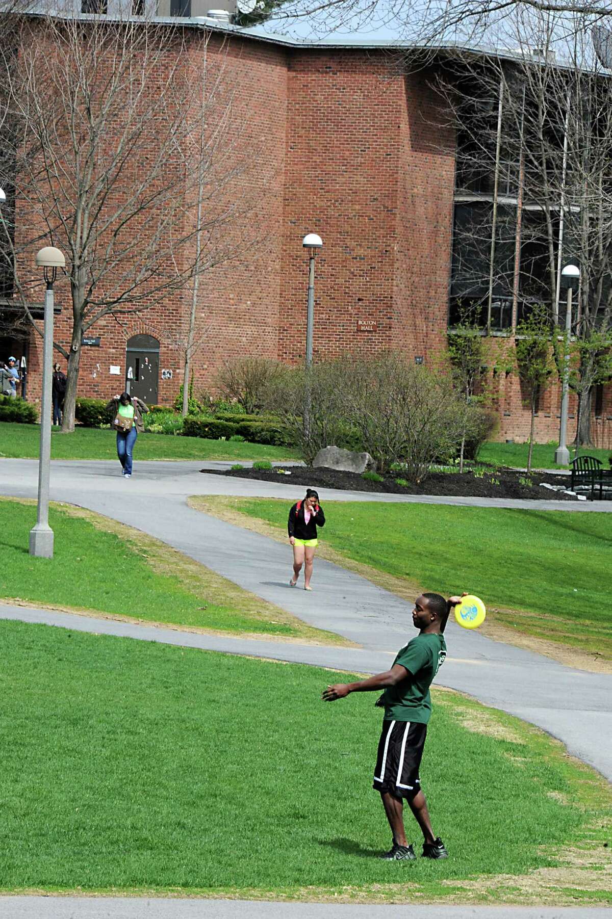 Students walk and play frisbee on the Skidmore College campus on Tuesday May 6, 2014 in Saratoga Springs, N.Y. (Lori Van Buren / Times Union)