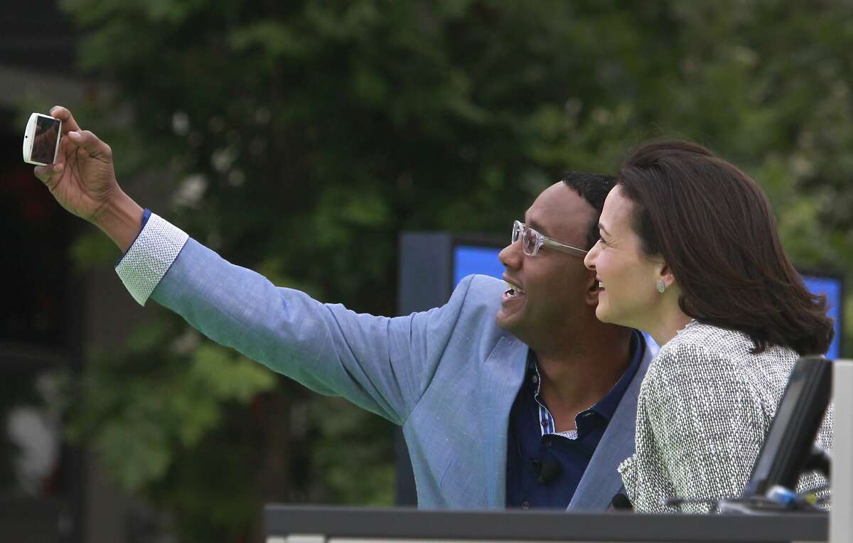 Featured speaker and emcee Mario Armstrong shoots a selfie with Facebook chief operating officer Sheryl Sandberg at a conference for small business owners at Facebook's headquarters in Menlo Park, Calif. on Tuesday, Aug. 5, 2014. The Facebook Fit bootcamp at the social network's campus capped a five-city tour designed to help small businesses maximize their opportunities on the web.