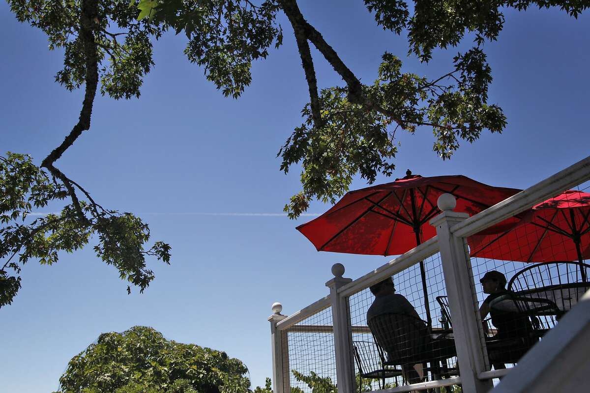 People enjoy the views from the tasting room's patio at Burrell School in Los Gatos, Calif., on Thursday, July 31, 2014.