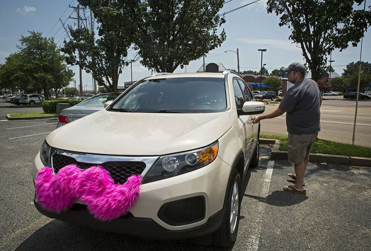 July 14, 2014 - Lyft driver Geoffrey Frisch, 36, enters his vehicle before heading to the Memphis International Airport Monday afternoon, July 14, 2014. Memphis has issued a cease-and-desist order against the ride-share service, which has been in service in the city since April, until they meet the same regulatory requirements as taxis and other vehicles for hire. (AP Photo/The Commercial Appeal, Yolanda M. James)