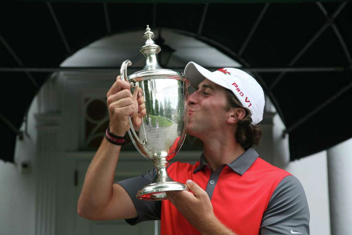 David Pastore kisses the winner's trophy after capturing the 112th Met Amateur championship on Sunday, August 3, 2014 at The Creek in Locust Valley, N.Y.