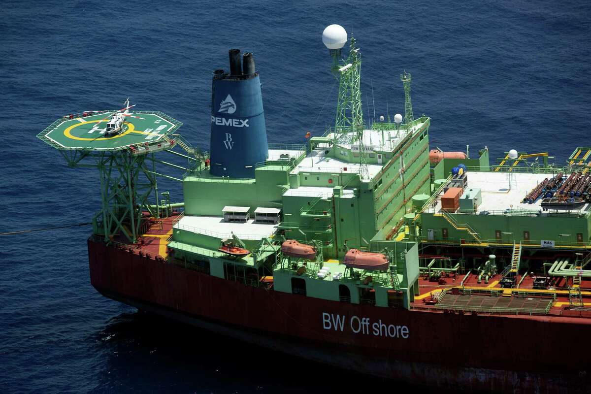 A helicopter sits on the helipad of the Yuum K'ak' Naab floating production, storage and offloading vessel operated by Pemex off the coast of Ciudad del Carmen. Mexican lawmakers are approving measures implementing an overhaul of the energy industry.