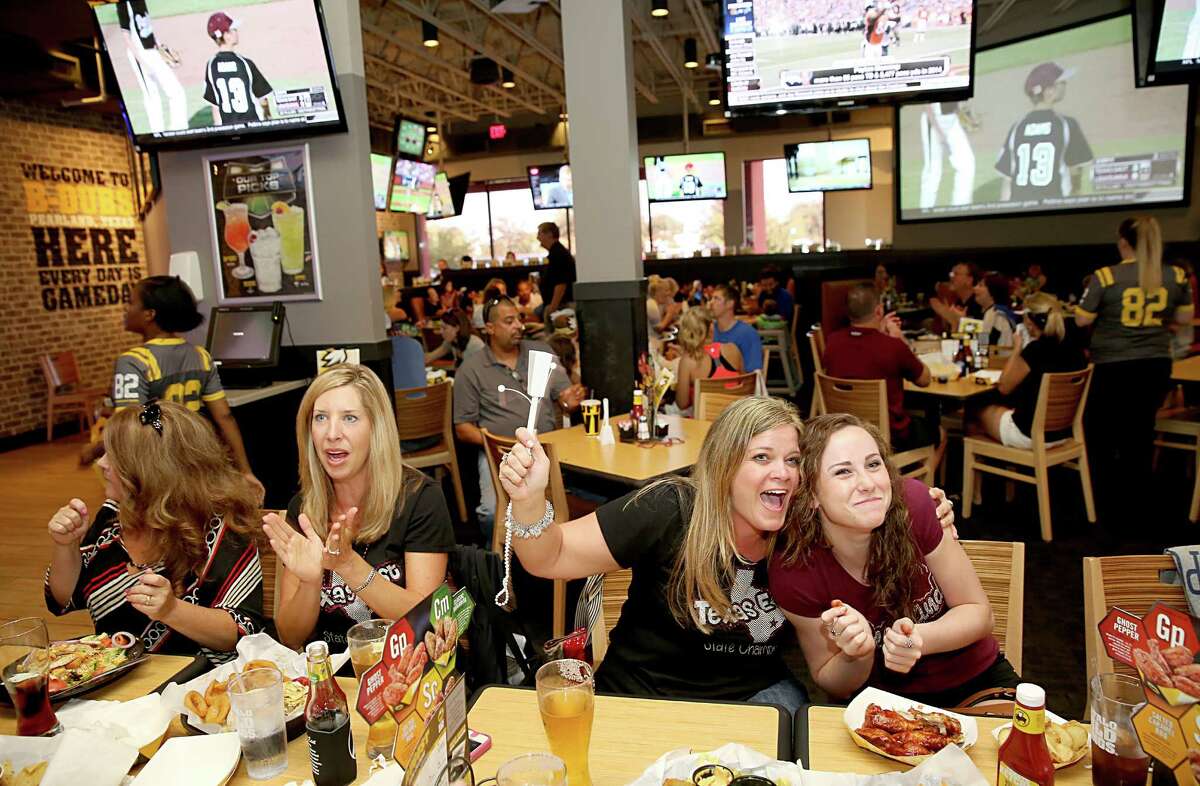 8/6/2014: From left to right, Jennifer Raffety, Annalea Young and Jordan Groover cheer as Pearland scores against Lake Charles at the Buffalo Wild Wings watch party in Pearland for the Pearland East Little League team, which is playing in the Southwest Regional final in Waco, TX. Jordan's brother is Michael Groover who is the third baseman for Pearland.