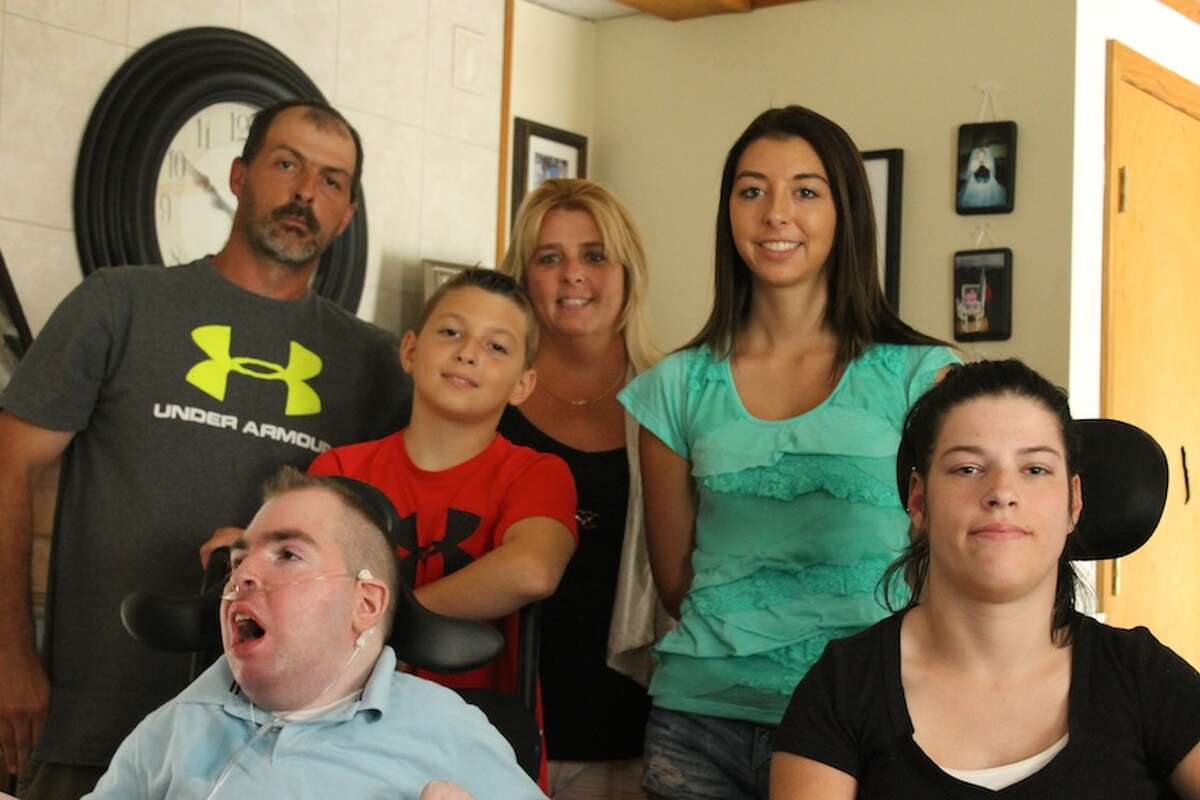 The White family is holding a fundraiser Aug. 24 to raise money for a wheelchair van. Pictured from left are: Keith White Sr.; Keith Jr., 22; Jacob, 10; Eileen; Sierra, 17; and family friend Veronica Alber, 20. (Christopher Lisio/Special to the Times Union)