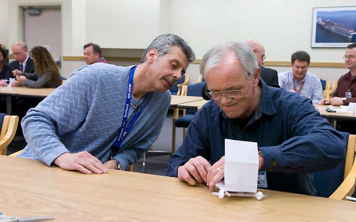 Bob Geiger and Charlie Hawley put the finishing touches on their teams puff mobile to compete in the Engineering Wars at Northrup Grumman in Norwalk, Conn. on Thursday, Feb. 18, 2010.