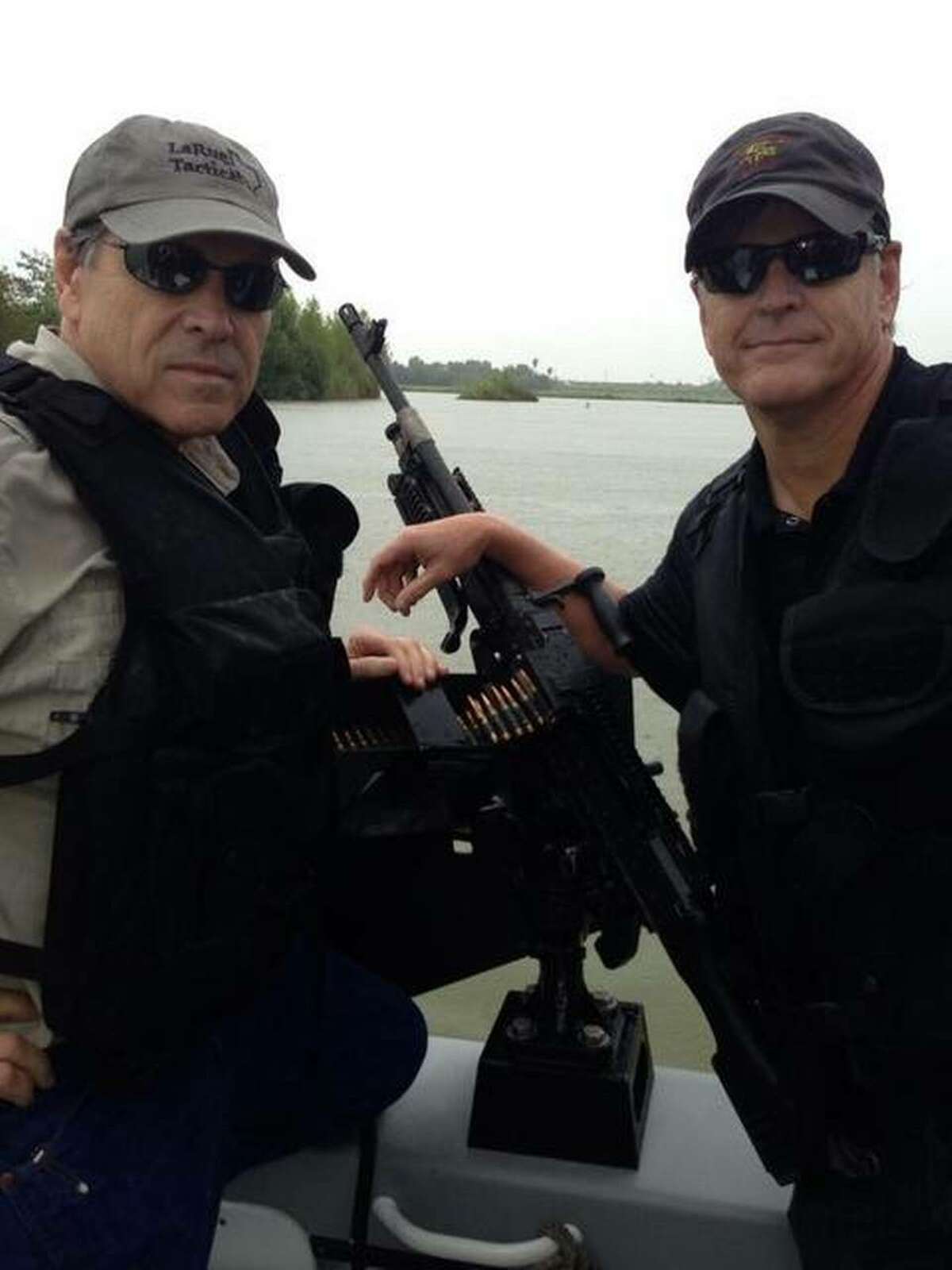 Gov. Rick Perry (left) poses for a photo op on a Department of Public Safety gun boat with Fox News host Sean Hannity during a July 2014 trip to the border.