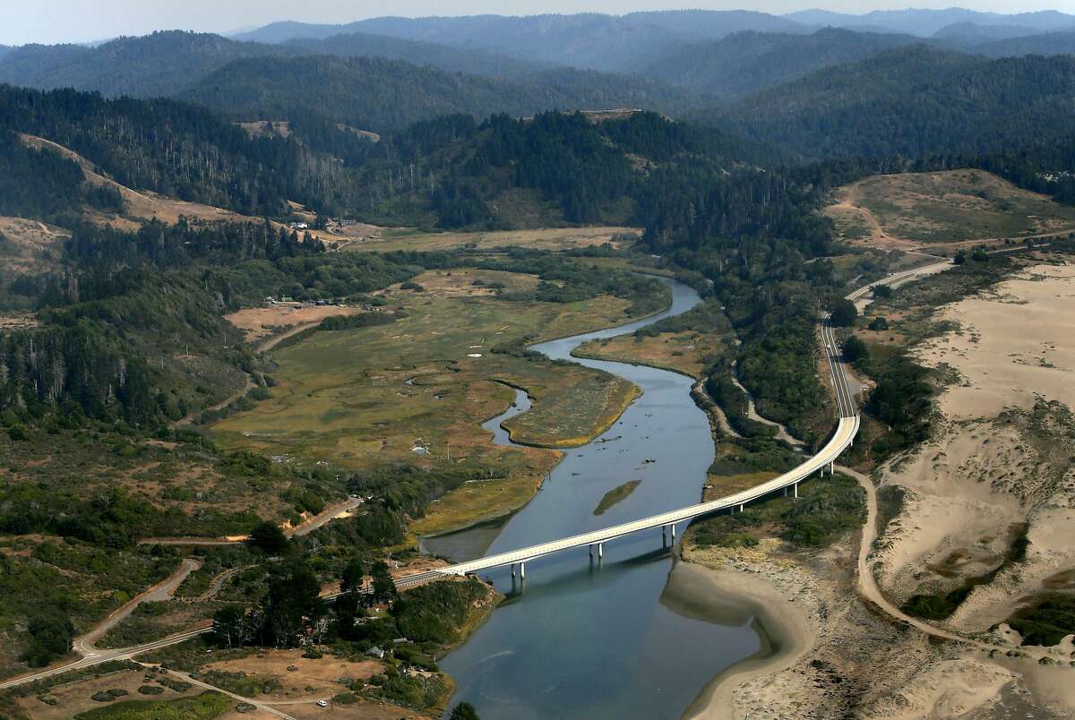 The Ten Mile River estuary as it reaches the Pacific Ocean, with Highway 1 in the foreground, as seen from the air on Wednesday Aug. 6, 2014. The Nature Conservancy has reached an easement agreement with the Perry Smith ranch to begin a restoration project and protect 872 acres of land, near Fort Bragg, Calif.