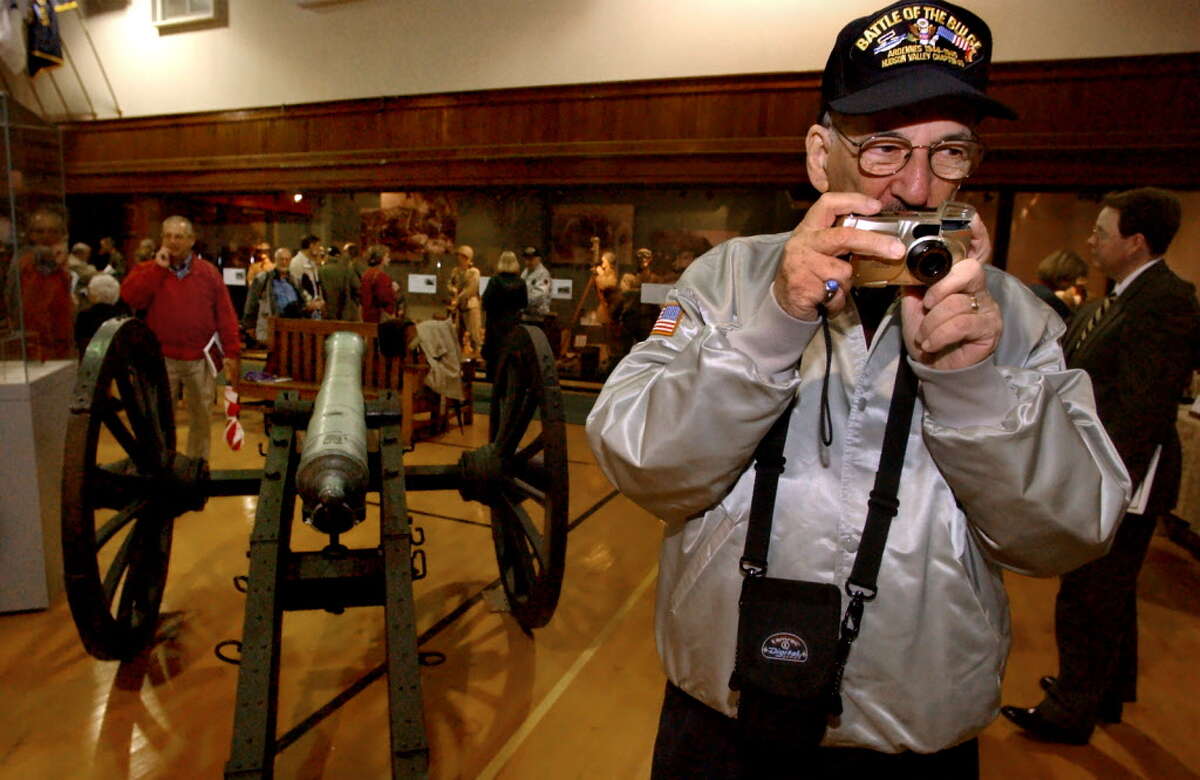 World War II veteran Richard Marowitz of Albany takes a picture of an exhibit on opening day of the state Military Museum and Veterans Research Center in 2002 in Saratoga Springs, N.Y. (Cindy Schultz/Times Union archive)