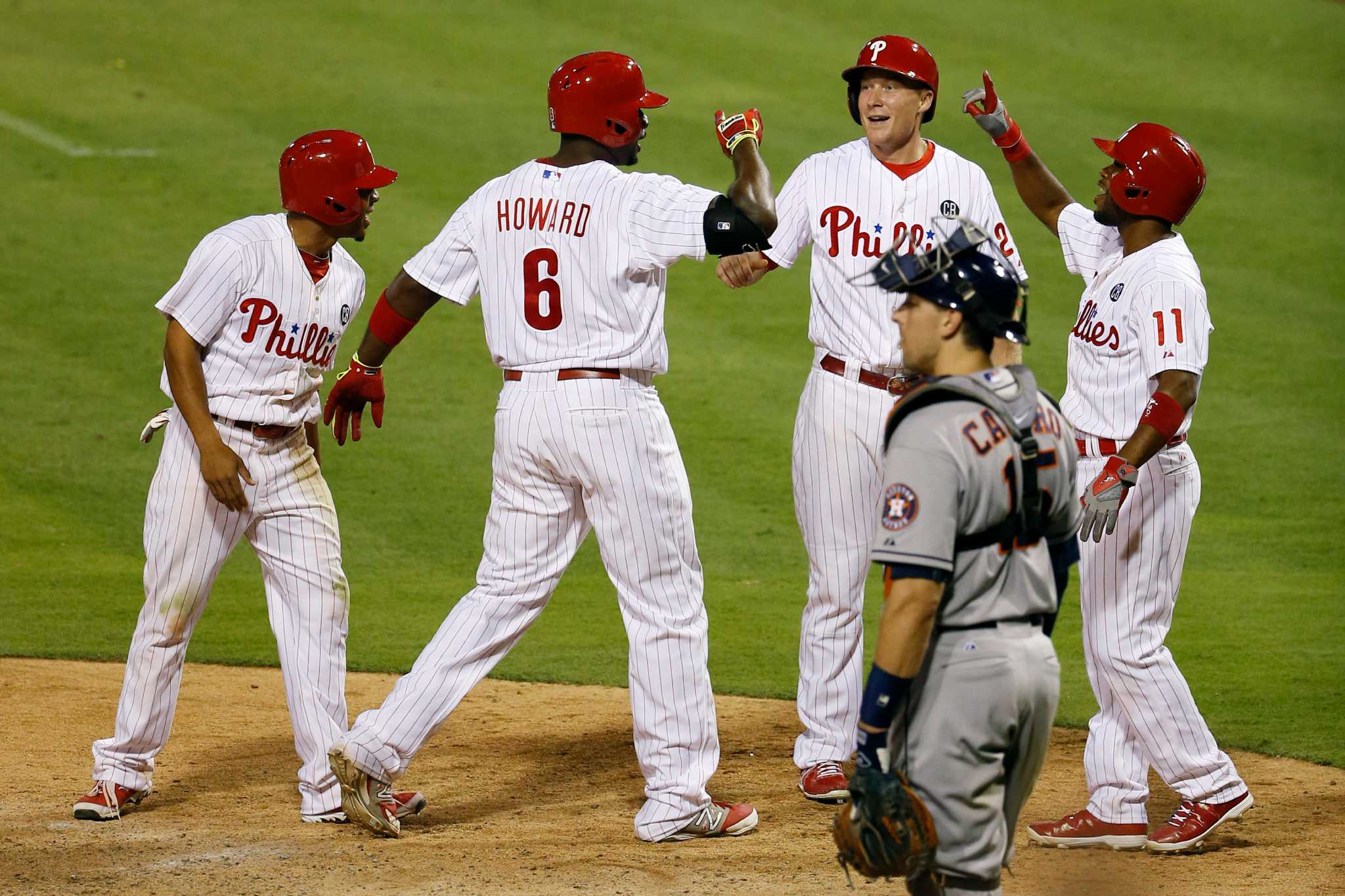 Philadelphia Phillies' Chase Utley tries to flip a ball to Jimmy