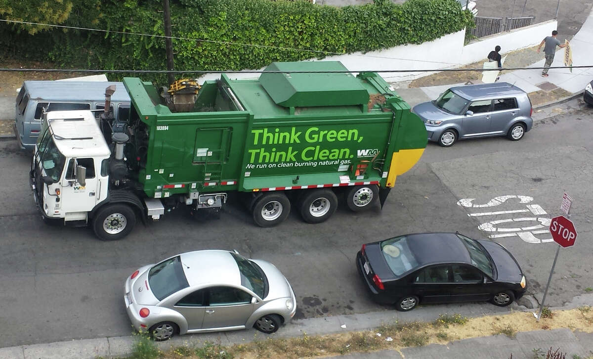 A Waste Management truck works a route in Oakland.