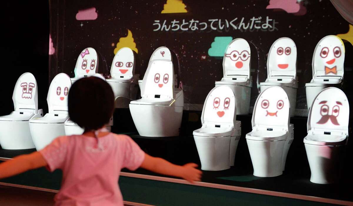 A child dances as she listens to a song by toilet bowls 