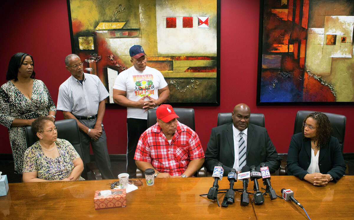 Donald Deason, lower left, Bruce Lawson, lower center, and attorney Shannon Baldwin, right, speak during a news conference, Friday, Aug. 8, 2014, in Houston. Mabrie Memorial Mortuary mixed up the deceased bodies of Donald and Bruce's mothers, Edna L. Lawson and Pearlie Jean Deason and buried Deason's body in Lawson's cemetery plot at the VA cemetery on top of the body of Lawson's deceased husband, a World War II Veteran. Lawson passed away on July 19, 2014 and Mrs. Deason passed away on July 22, 2014.