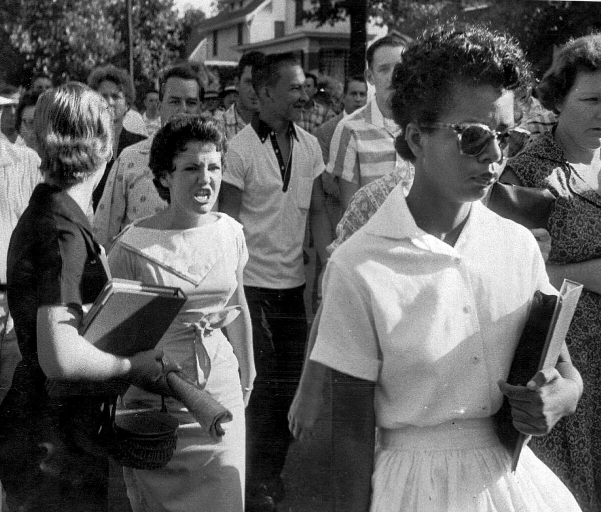 Hazel Bryan (center) and other students at Central High School in Little Rock, Ark., heckle Elizabeth Eckford as she walks by Sept. 4, 1957. Bryan later apologized to Eckford.