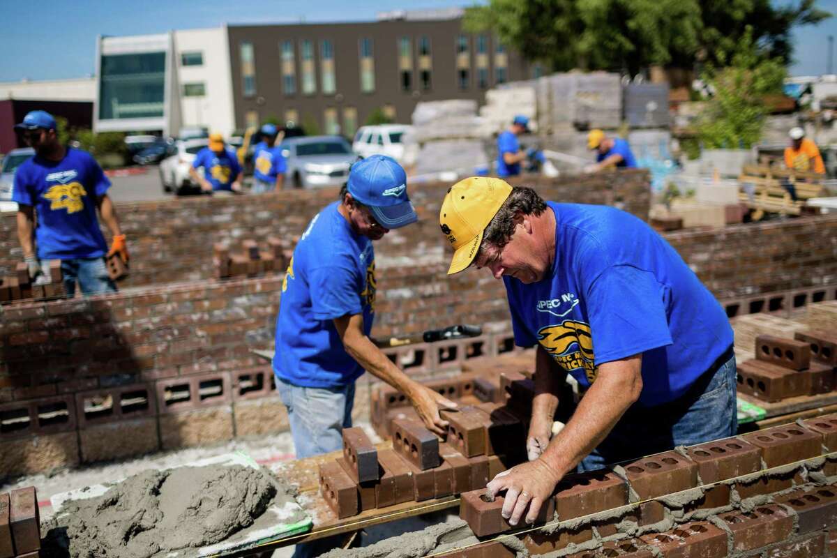Pitted against opposing teams, skilled masons and their assistants - known as "tenders" - race against the clock to stack up organized walls of bricks at the fifth annual World Series of Bricklaying Friday, August 8, 2014, in Seattle, Wash. Craftsmen representing the state of Washington competed for cash and the opportunity to advance to the National Championship competition held next year in Las Vegas.