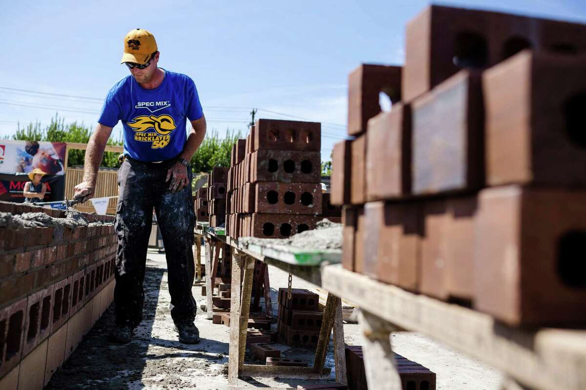 Jason Larimore, of Fairweather Masonry, races against the clock to stack up organized walls of bricks at the fifth annual World Series of Bricklaying Friday, August 8, 2014, in Seattle, Wash. Craftsmen representing the state of Washington competed for cash and the opportunity to advance to the National Championship competition held next year in Las Vegas.