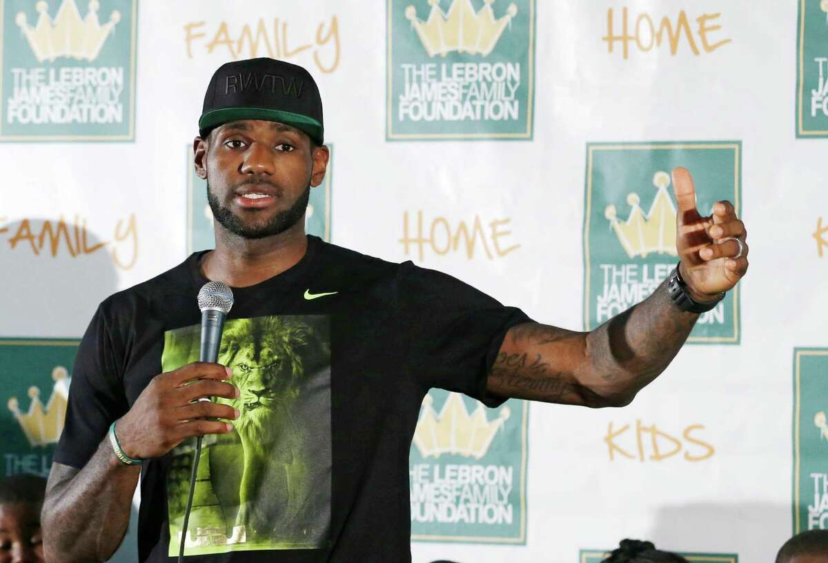 Cleveland Cavaliers' LeBron James answers questions during a news conference before the homecoming event at InfoCision Stadium, Friday, Aug. 8, 2014, in Akron, Ohio. (AP Photo/Tony Dejak) ORG XMIT: OHTD105