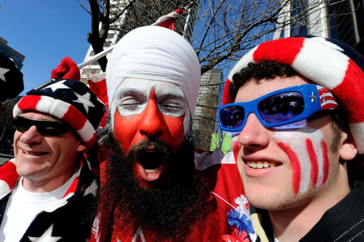 VANCOUVER, BC - FEBRUARY 18: (L-R) Shane Moncrieff of Portland, Oregon, Amarjeet Jandhu of Surrey, Canada and Dylan Moncrieff (son of Shane) enjoy downtown Vancouver on day seven of the Vancouver 2010 Winter Olympics on February 18, 2010 in Vancouver, Canada. (Photo by Kevork Djansezian/Getty Images) *** Local Caption *** Shane Moncrieff;Amarjeet Jandhu;Dylan Moncrieff