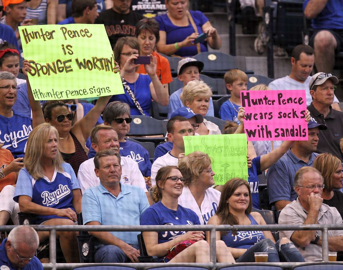 Fans hold up signs as San Francisco Giants' Hunter Pence bats in the first inning during a baseball game against the Kansas City Royals, Friday, Aug. 8, 2014, in Kansas City, Mo. (AP Photo/Ed Zurga)