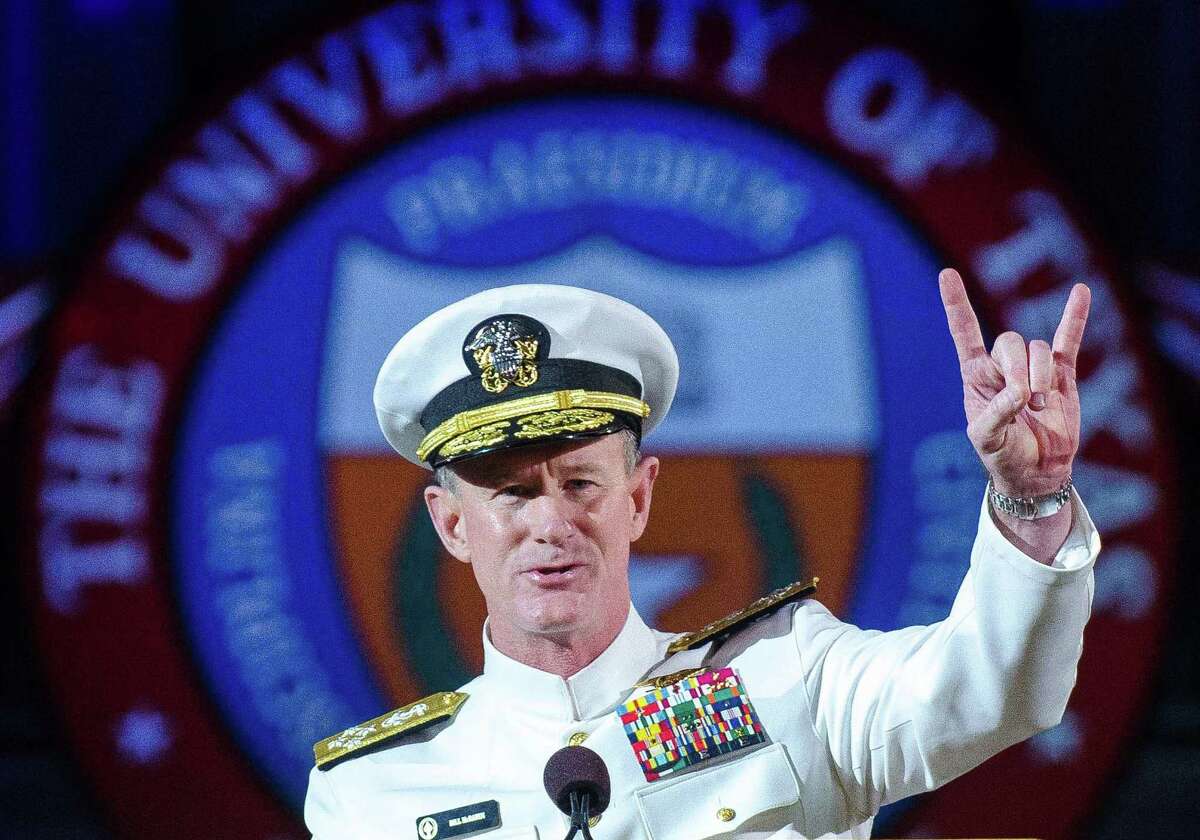 Adm. William H. McRaven, makes the Hook 'em Horns hand signal during his commencement address at the University of Texas in Austin in May.