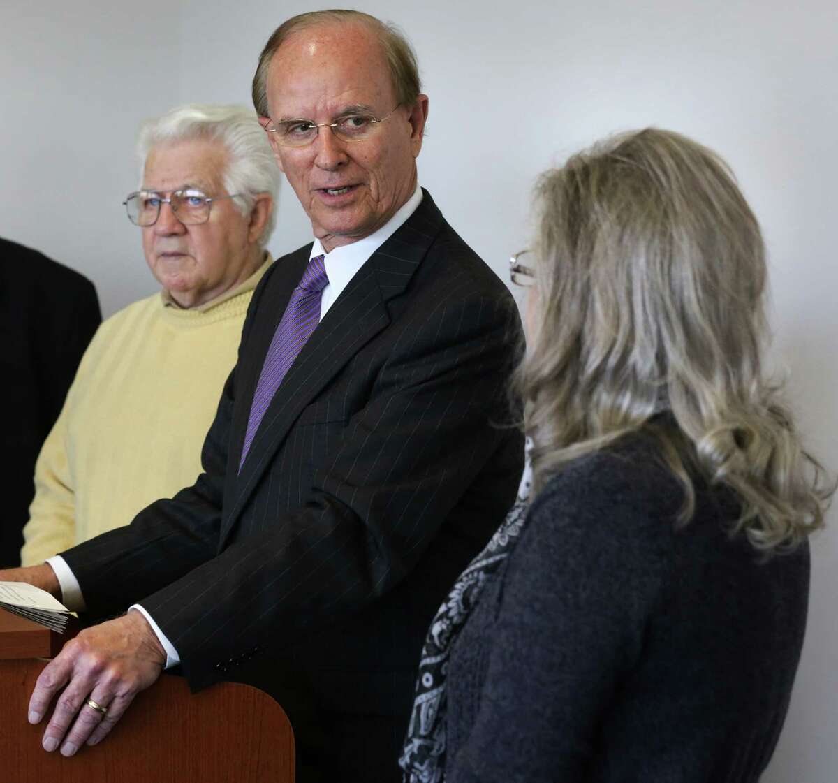 Members of the Committee to Incorporate City of Sandy Oaks, Charlotte Rabe (right) and Jim Clement (left), listen as Bexar County Judge Nelson Wolff announces the committee's filing to become a city in January. Clement was elected the new city's first mayor on Saturday.