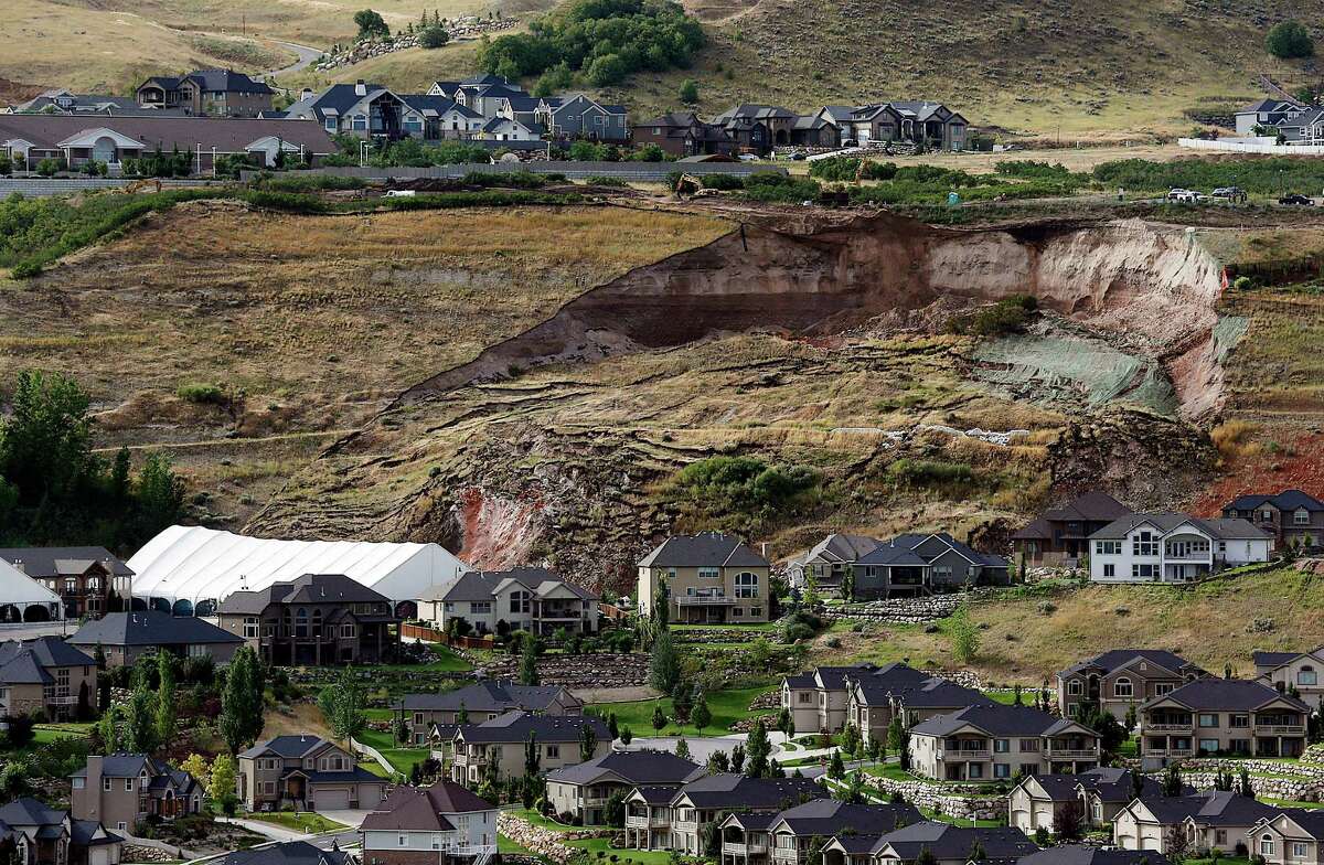 This Tuesday, Aug. 5, 2014 photo shows the area of a landslide in a hillside community of North Salt Lake, Utah. One home has been destroyed and at least a dozen others have been evacuated. (AP Photo/The Deseret News, Ravell Call)