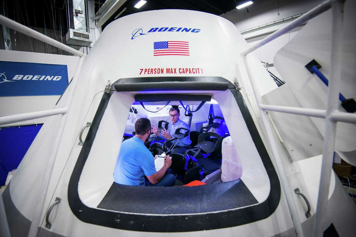 Chris Ferguson, director of Crew and Mission Operations for Boeing's Commercial Crew Program, facing, works with engineer Brandon Setayesh in a mockup of the CST-100 crew capsule at the the company's Houston Product Support Center on Thursday, July 24, 2014, in Houston. The capsule is Boeing's proposed spacecraft for NASA's Commercial Crew Development program. Ferguson, a former astronaut, commanded STS-135, the final Space Shuttle mission. ( Smiley N. Pool / Houston Chronicle )