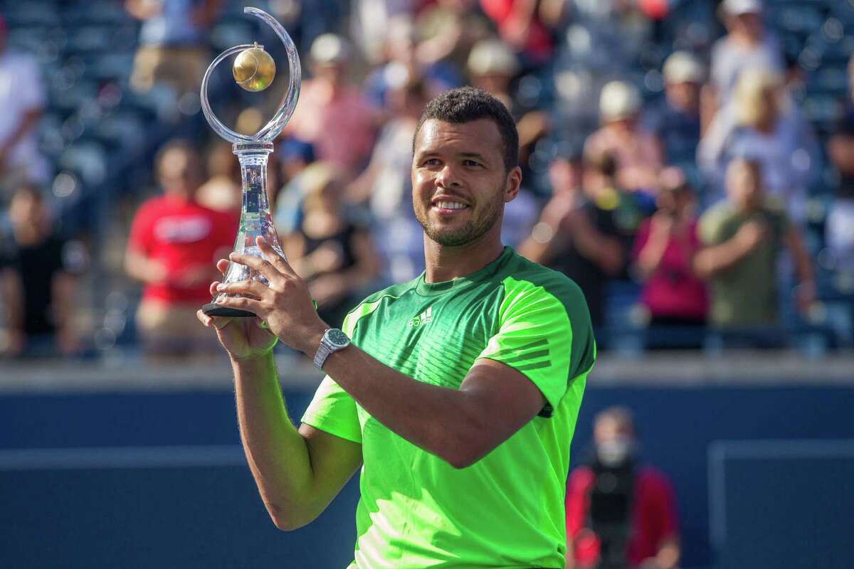 Jo-Wilfried Tsonga holds the Rogers Cup after defeating Roger Federer of Switzerland 7-5, 7-6 in the final of the Rogers Cup at Rexall Centre in Toronto, Ontario, August 10, 2014. AFP PHOTO / Geoff RobinsGEOFF ROBINS/AFP/Getty Images