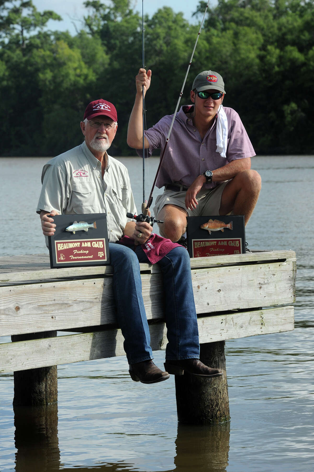 The Beaumont A&M Club will host its 17th annual fishing tournament at Pleasure Island on Saturday. Nick Prewitt and Tom Natho hold their fishing rods and plaques that will be handed out at Colliers Ferry Park on Friday. Photo taken Friday, August 08, 2014 Guiseppe Barranco/@spotnewsshooter