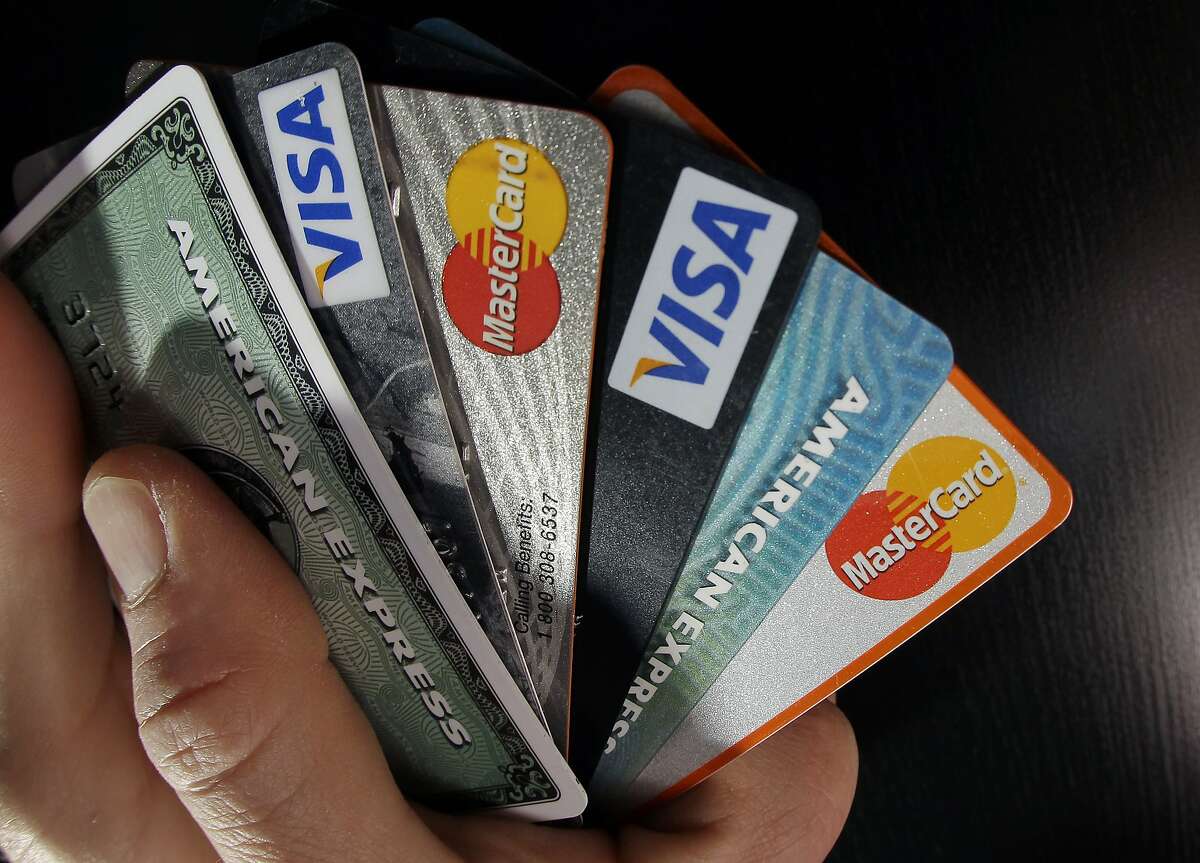 In this March 5, 2012 photo, consumer credit cards are posed in North Andover, Mass. Consumer borrowing rose by $17.8 billion in January, the Federal Reserve said Wednesday, March 7, 2012. That followed similar gains in December and November. (AP Photo/Elise Amendola)