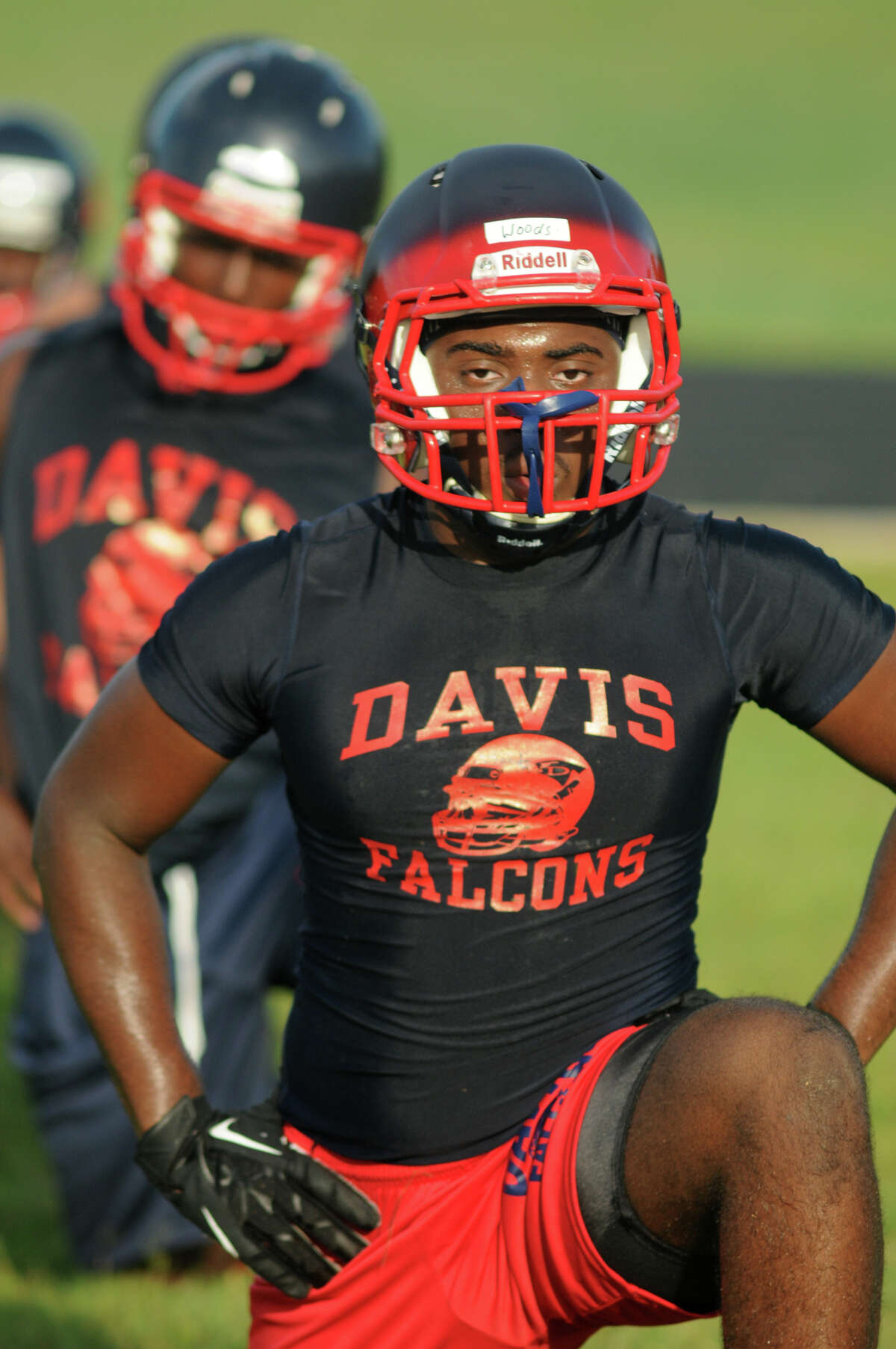 Aldine Davis junior linebacker Brian Woods work through their warm-up calisthenics on the first day of practice for the school which is in its first year of varsity football this season.
