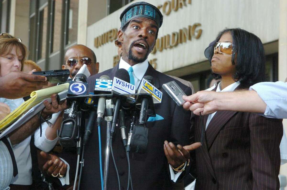 Former Senator Ernie Newton (center) talked to the press after pleading guilty to three counts Sept. 20th, 2005 at the federal courthouse on Lafayette Street in Bridgeport. Ernie's sister Patricia Newton-Foster is at right.