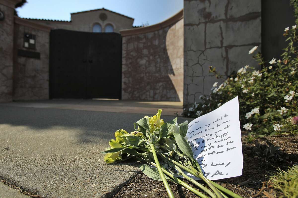 A small bouquet of flowers and note were placed at the front gate at Robin Williams' former home in the Sea Cliff neighborhood in San Francisco, Calif., on Monday, August 11, 2014. Williams was found dead in his Tiburon home earlier in the day and fans and friends left flowers and notes to honor the comedy and acting legend.