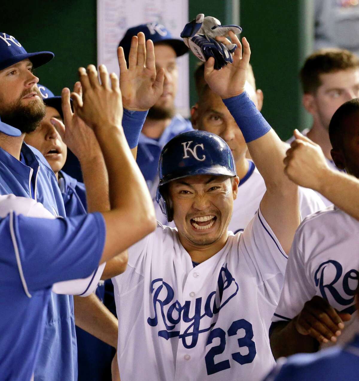 The Royals' Norichika Aoki (23) is all smiles in the dugout after scoring the go-ahead run in the seventh inning of Monday's game against the Athletics. Kansas City held on for a 3-2 victory, its eighth in a row, pushing it past the Tigers for the top spot in the AL Central.