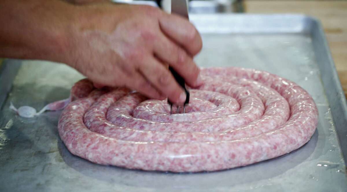 Ryan Farr of 4505 Meats makes beer brats on Tuesday, July 15, 2014 in San Francisco, Calif.