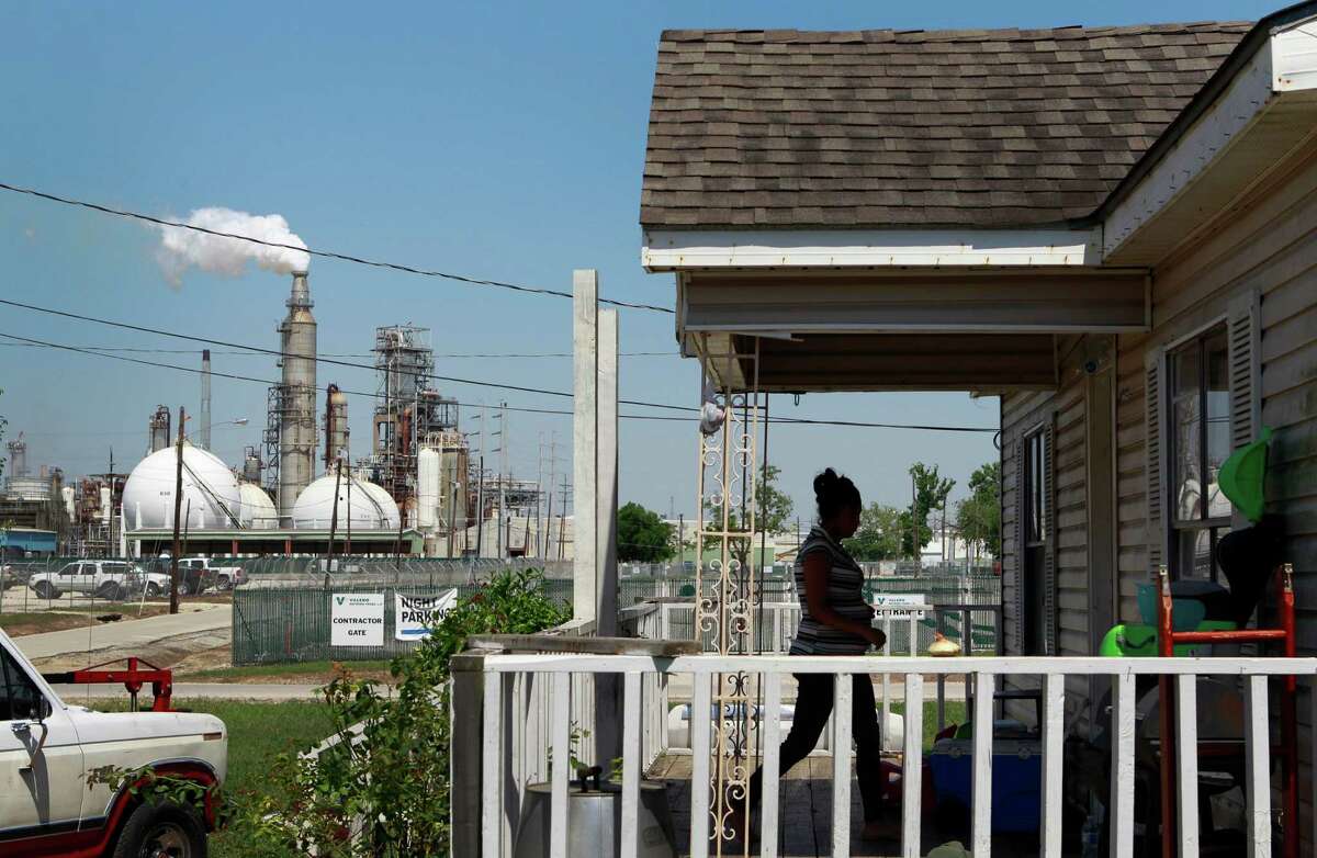 Griselda Silva walks into her sister's home along East Avenue P at Central St. across from the Valero Houston Refinery Thursday, May 15, 2014, in Houston. 