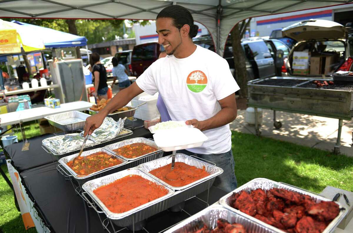 Sim Singh, of The Mango Tree Indian Takeout and Cuisine, serves an Indian dish at the Jai Ho Indian Festival at CityCenter Green in Danbury, Conn. on Saturday, Aug. 17, 2013. The festival, presented by the Indian Association of Western CT, returns in 2014 on Saturday, Aug. 16, 11:30 a.m. to 10 p.m.