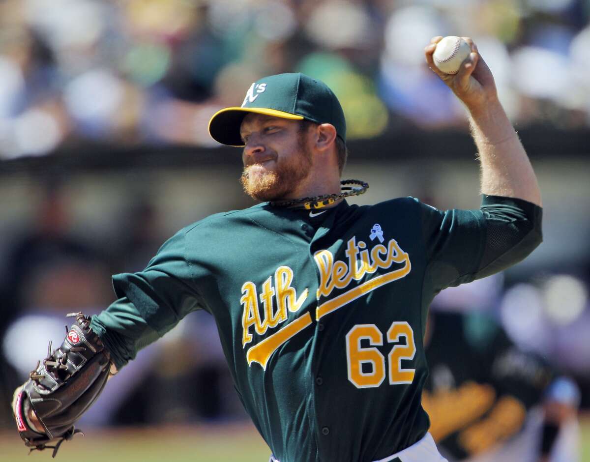 Oakland A's pitcher Bartolo Colon throws to the Seattle Mariners