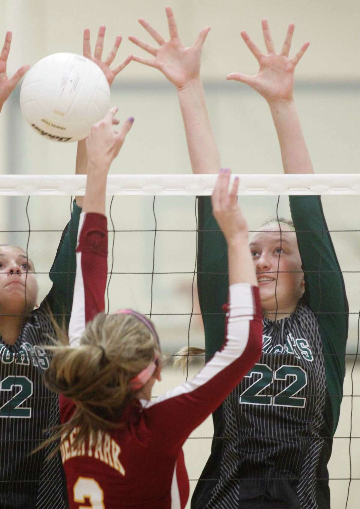 Clear Fall's Jennifer Wieland (2) and Sophie Schaff (22) defend against Deer Park's Haley Schneider during a high school volleyball game on Tuesday, Aug. 12, 2014, in Deer Park.