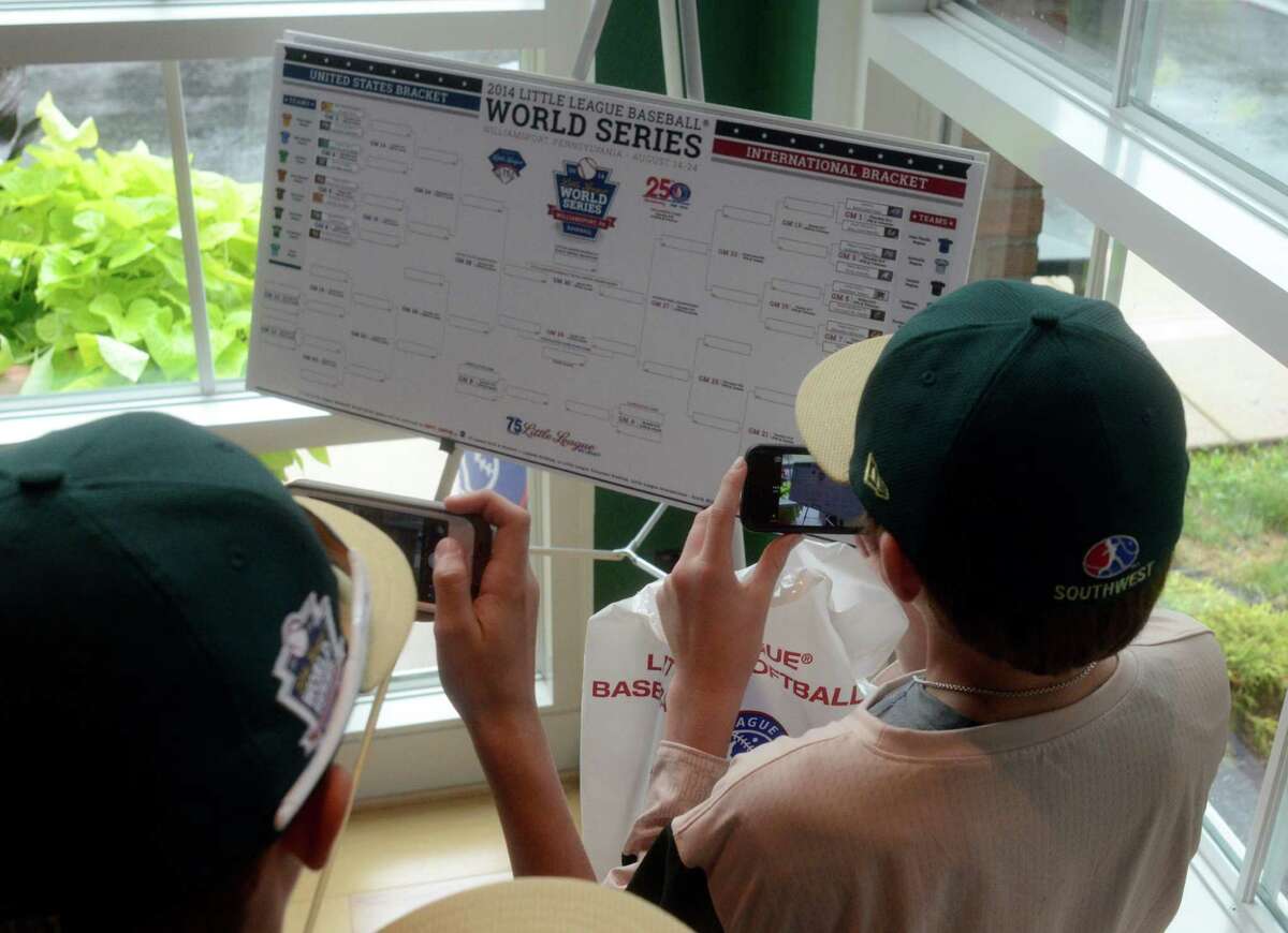 Players from Pearland Little League take photos of the game bracket on their phones during a tour of the World of Little League Museum in Williamsport, Pa on Tuesday, August 12, 2014. From left are, Michael Groover, Mathew Adams, Bryce Laird, Cole Smajstria and Landon Donley.