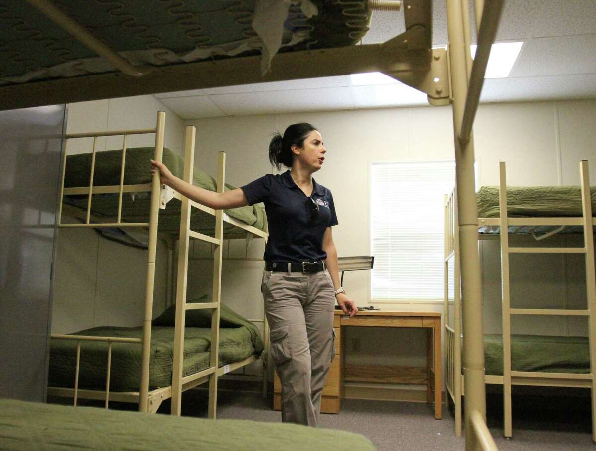 Barbara Gonzalez, public information officer for Immigration and Customs Enforcement, shows a dormitory where migrant families are housed at the Artesia Residential Detention Facility.