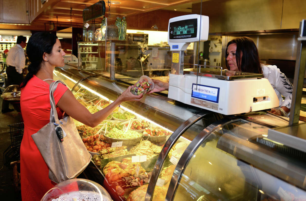 Paula Garelick of Garelick & Herbs, right, serves customer Jessica Davenport, of Fairfield, at the store on Post Road in Westport, Conn. on Tuesday, August 12, 2014.